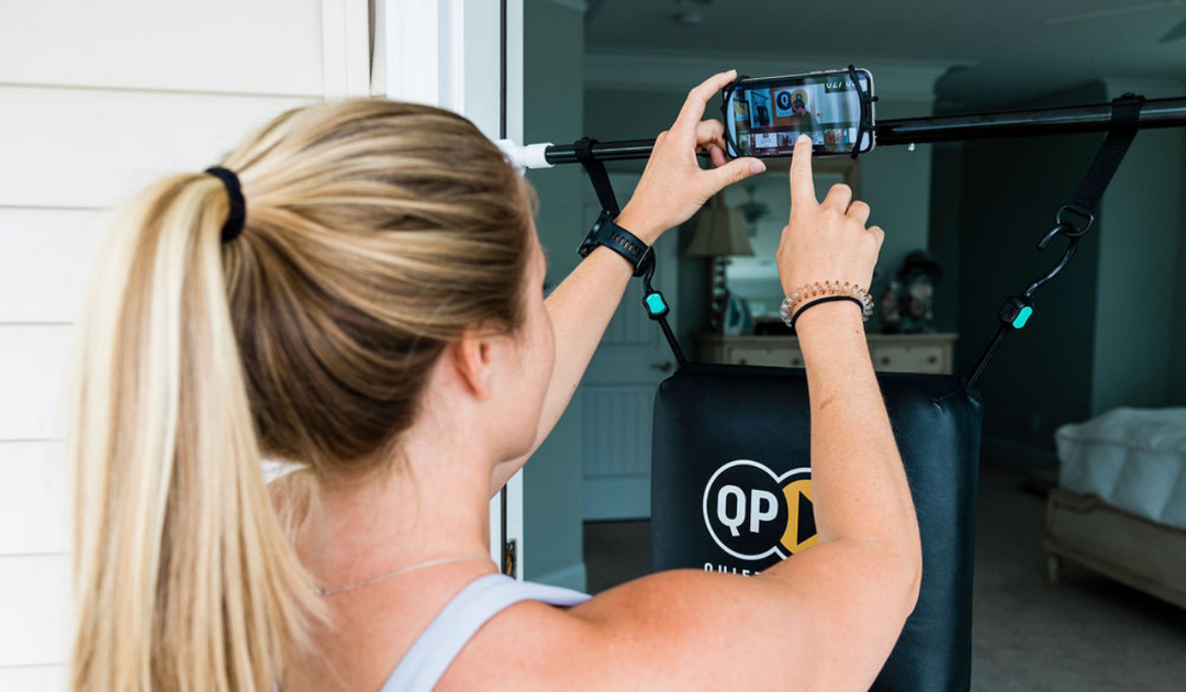 Home boxing session with a woman using the Quiet Punch punching bag in her bedroom
