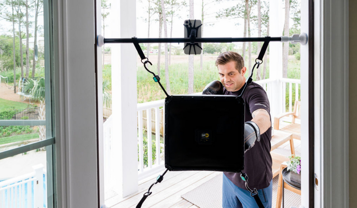 Man practicing combos on the Quiet Punch punching bag in doorway setup